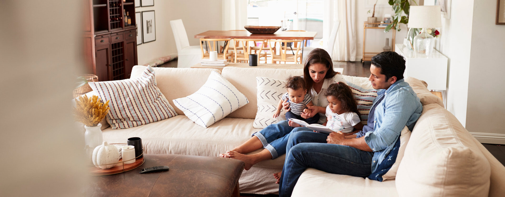 Family reading book in comfortable home